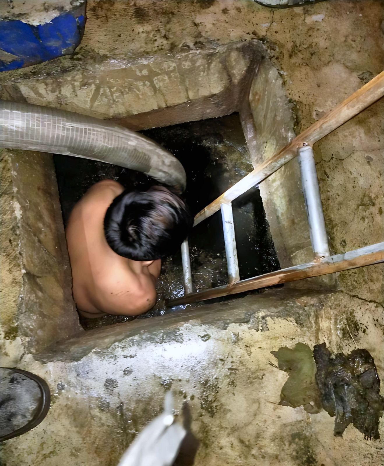 Malabanan P&M actual work: Siphoning every corner — Inside the tank with the vacuum hose, so the whole pozo negro is emptied, not just the top layer.
